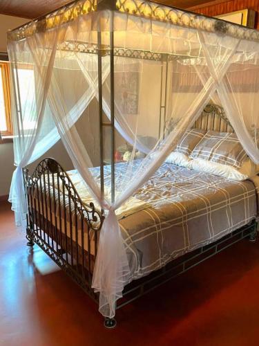 a bed with a canopy in a room at Waterfront Sunset Cabin with Patio and Firepit 2 bdrm in Saint Joseph