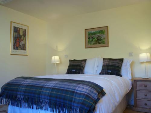 a bedroom with a large bed with two pillows at The Barn in Loxton