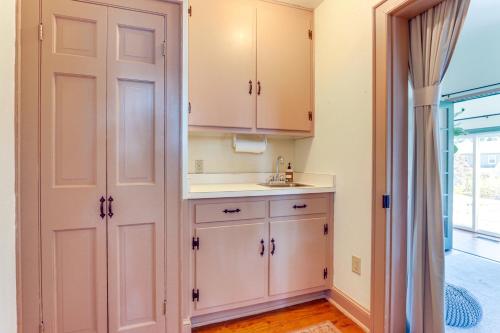 a kitchen with white cabinets and a sink at Walkable Location Historic Home in Charles Town! in Charles Town