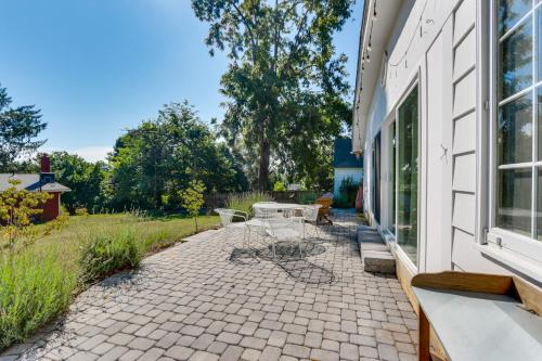 a patio with a table and chairs next to a building at Walkable Location Historic Home in Charles Town! in Charles Town