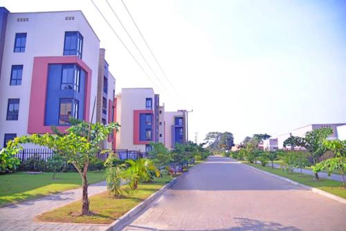 an empty street in a city with buildings at Betty's Apartments in Ntabwe