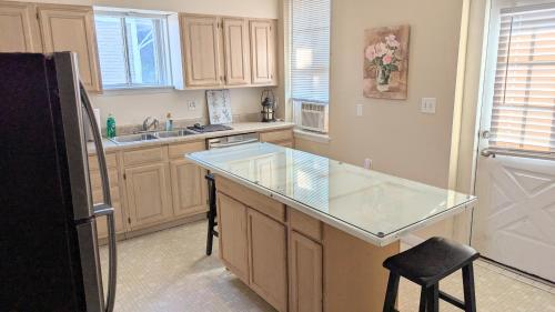 a kitchen with a counter with a glass counter top at Relaxing Rustic Oasis II, Unit B - 6 minute walk to Downtown! Cyclists Welcome! in Cumberland