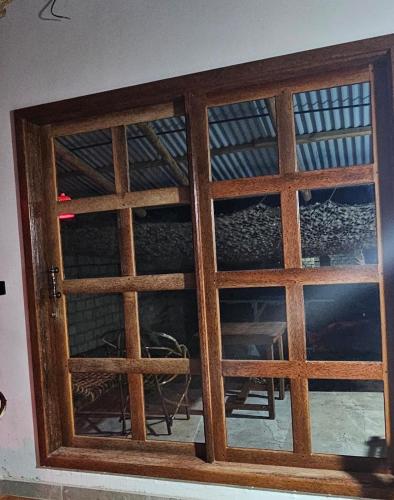 a wooden door with a window in a room at Morena villa in Kendwa