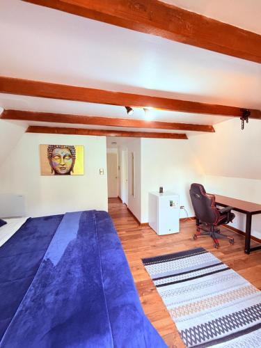 a bedroom with a blue bed and a desk at MAKTVB Costanera - Hostal Boutique in Santiago
