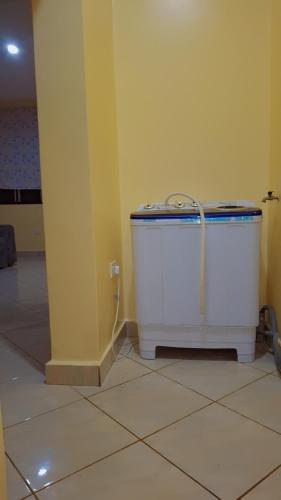 a bath tub sitting in the corner of a room at Indian ocean apartments you get the master bedroom with the private bathroom and the host sleeps in the other bedroom you share kitchen anc living room in Mombasa