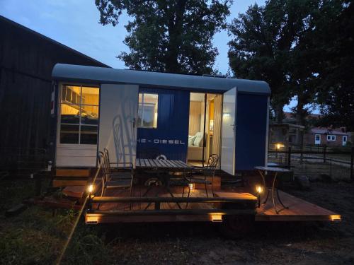 a tiny house sitting on a trailer with lights at Bauwagen, Noltenius in Bülstedt