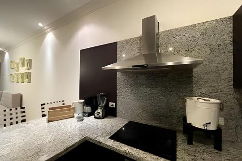a kitchen with a sink and a stove at Puerta Cabos Village in Cabo San Lucas