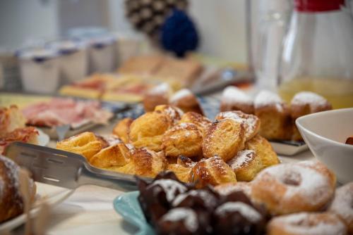 a bunch of donuts on a table with a knife at Terra d'amare in Castelluzzo