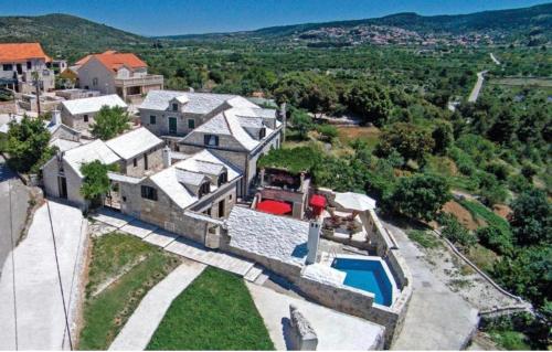 an aerial view of a house with a swimming pool at Humac Vero Apartments in Donji Humac