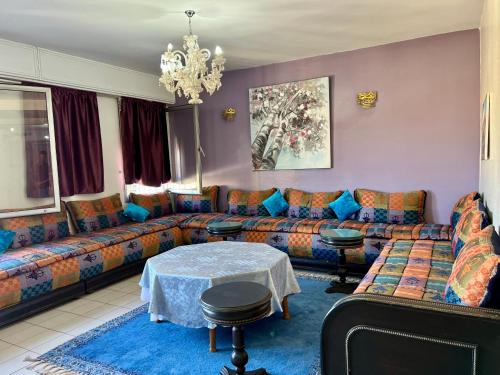 a living room with a couch and a table at Luxury appartement centre ville Fes - French Touch in Fès