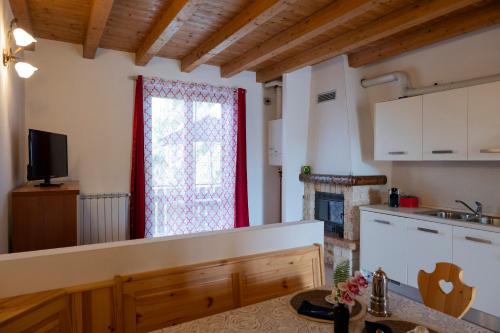 a kitchen with a large window and a table at Mountain Lake Endine- Iseo Milly's Home in Bianzano