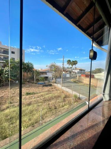 a view of a field from a window at Hotel Vila Solar in Limeira