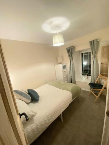 a bedroom with a bed with two pillows on it at Cute Cornish Cottage in Saint Germans