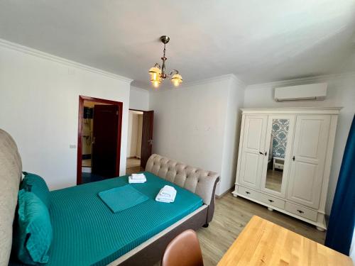 a living room with a couch and a table at Catedrala Blue in Constanţa