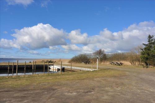 a dock with a boat in a field next to the water at 80011-Vemb-Harpotvej-84 in Skalstrup