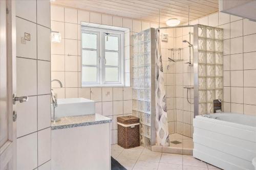 a bathroom with a tub and a sink and a shower at 10825-Ulfborg-Vester-Mosevej-35 in Øby