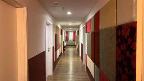 a corridor in a building with a long hallway at Hotel Gifhorn INN in Gifhorn