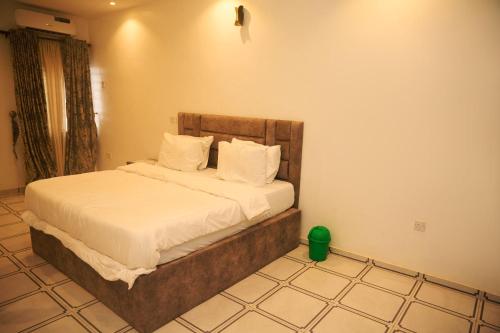 a bedroom with a bed in a room at Cremyark Homes in Benin City