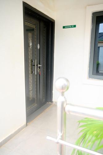 a black door on the side of a house at Cremyark Homes in Benin City