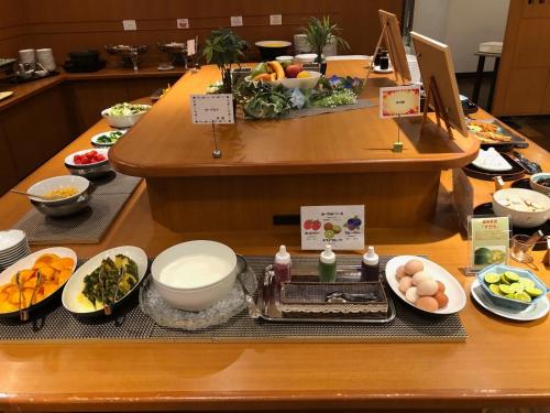 a buffet line with bowls and plates of food at Smile Hotel Tokushima - Vacation STAY 10491v in Tokushima