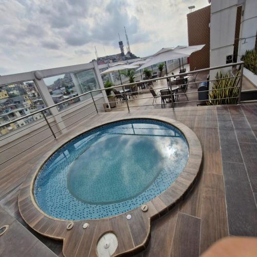 a swimming pool on the roof of a building at Vista al faro Habitacion doble in Guayaquil
