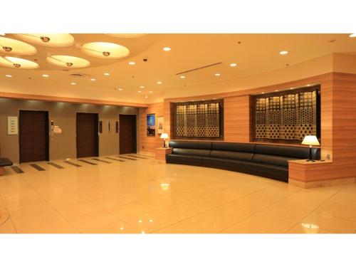 a lobby with couches and tables in a building at Smile Hotel Tokushima - Vacation STAY 10491v in Tokushima
