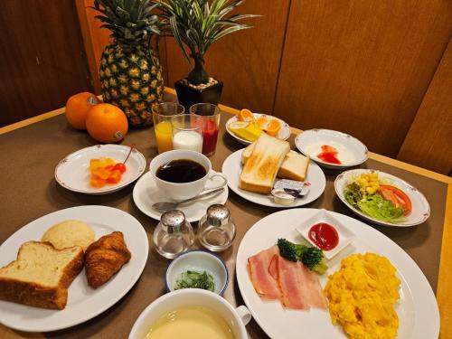 a table with plates of breakfast food on it at Smile Hotel Tokushima - Vacation STAY 10491v in Tokushima
