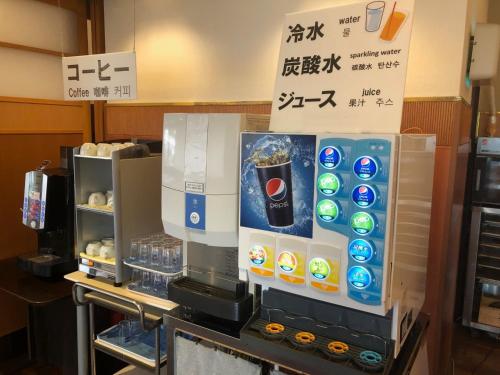 a drink dispenser in a restaurant with avertisement at Smile Hotel Tokushima - Vacation STAY 10498v in Tokushima