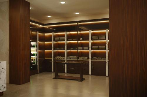 a room with a walk in closet with wooden cabinets at AC Hotel by Marriott Georgetown Guyana in Georgetown