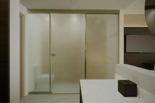 a glass door in a room with a table at AC Hotel by Marriott Georgetown Guyana in Georgetown
