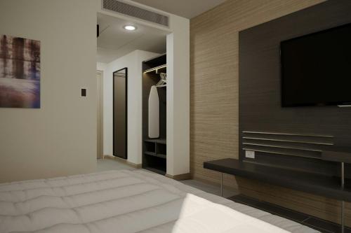 a living room with a flat screen tv on a wall at AC Hotel by Marriott Georgetown Guyana in Georgetown
