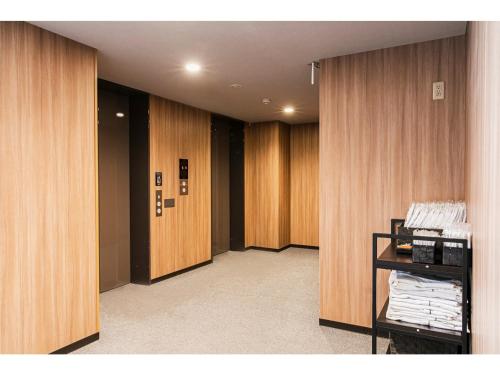 a hallway with wooden walls and wooden doors at Smile Hotel Hakata Ekimae - Vacation STAY 64019v in Fukuoka