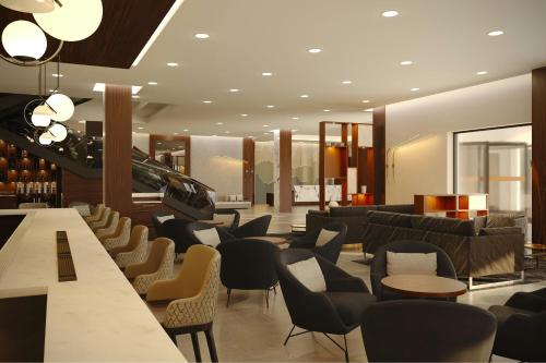 a restaurant with chairs and tables and a lobby at AC Hotel by Marriott Georgetown Guyana in Georgetown