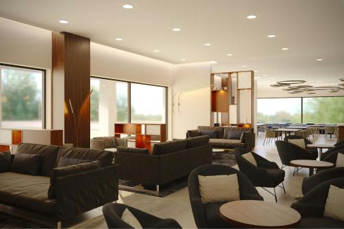 a living room with couches and chairs and a table at AC Hotel by Marriott Georgetown Guyana in Georgetown