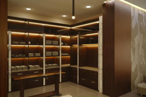 a walk in closet with wooden cabinets and a table at AC Hotel by Marriott Georgetown Guyana in Georgetown