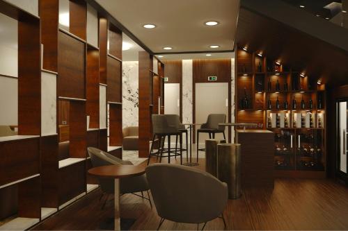 a bar with chairs and tables in a room at AC Hotel by Marriott Georgetown Guyana in Georgetown