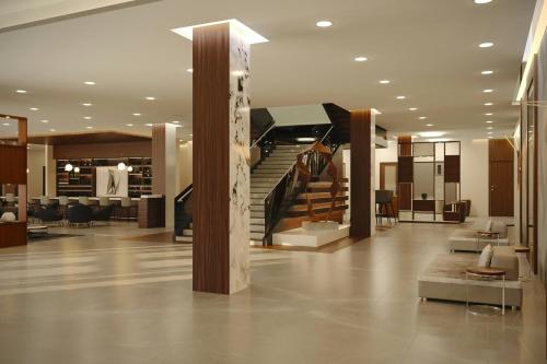 a lobby with a staircase in a building at AC Hotel by Marriott Georgetown Guyana in Georgetown