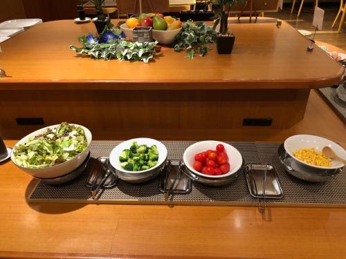 a group of bowls of vegetables on a table at Smile Hotel Tokushima - Vacation STAY 10502v in Tokushima