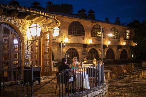 a man and a woman standing in front of a building at Casa de Campo Resort & Villas in La Romana