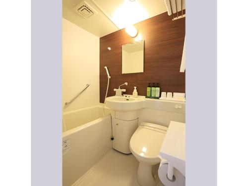 a bathroom with a toilet and a sink and a bath tub at Smile Hotel Hakata Ekimae - Vacation STAY 64014v in Fukuoka