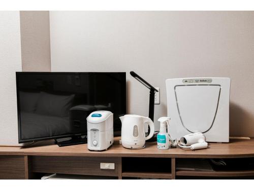 a desk with a tv and some appliances on it at Smile Hotel Hakata Ekimae - Vacation STAY 64014v in Fukuoka