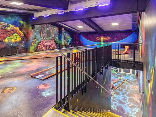 a staircase in a room with a mural at 6 Personen Ferienhaus in Wendtorf in Wendtorf