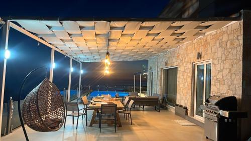 a patio with a table and chairs on a building at Ionian pool house in (( Lerë ))
