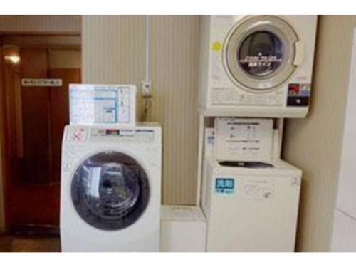 a washing machine and a dryer in a room at Smile Hotel Shimonoseki - Vacation STAY 12586v in Shimonoseki