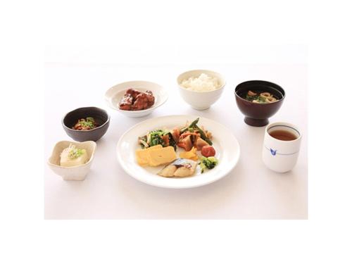 a table with a plate of food and bowls of food at Smile Hotel Shimonoseki - Vacation STAY 12586v in Shimonoseki