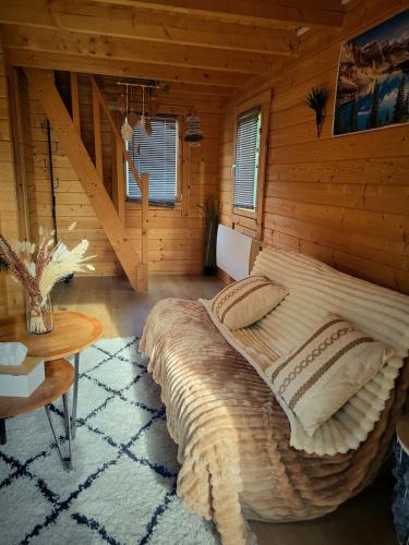 a bedroom with a large bed in a log cabin at Chalet cosy & jacuzzi privé - Paris & Disney in Ormesson-sur-Marne
