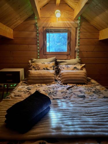 a bedroom with a large bed in a log cabin at Chalet cosy & jacuzzi privé - Paris & Disney in Ormesson-sur-Marne