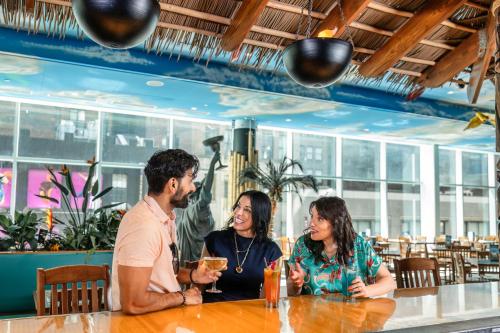 a group of people sitting at a table in a restaurant at Margaritaville Resort Times Square in New York