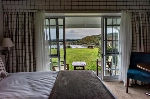 a bedroom with a bed and a window with a view at VR Rotorua Lake Resort in Rotorua