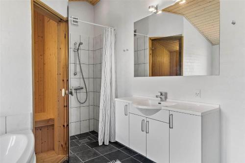 a white bathroom with a sink and a mirror at 10704-Ulfborg-Gaffelbjergvej-49 in Øhuse